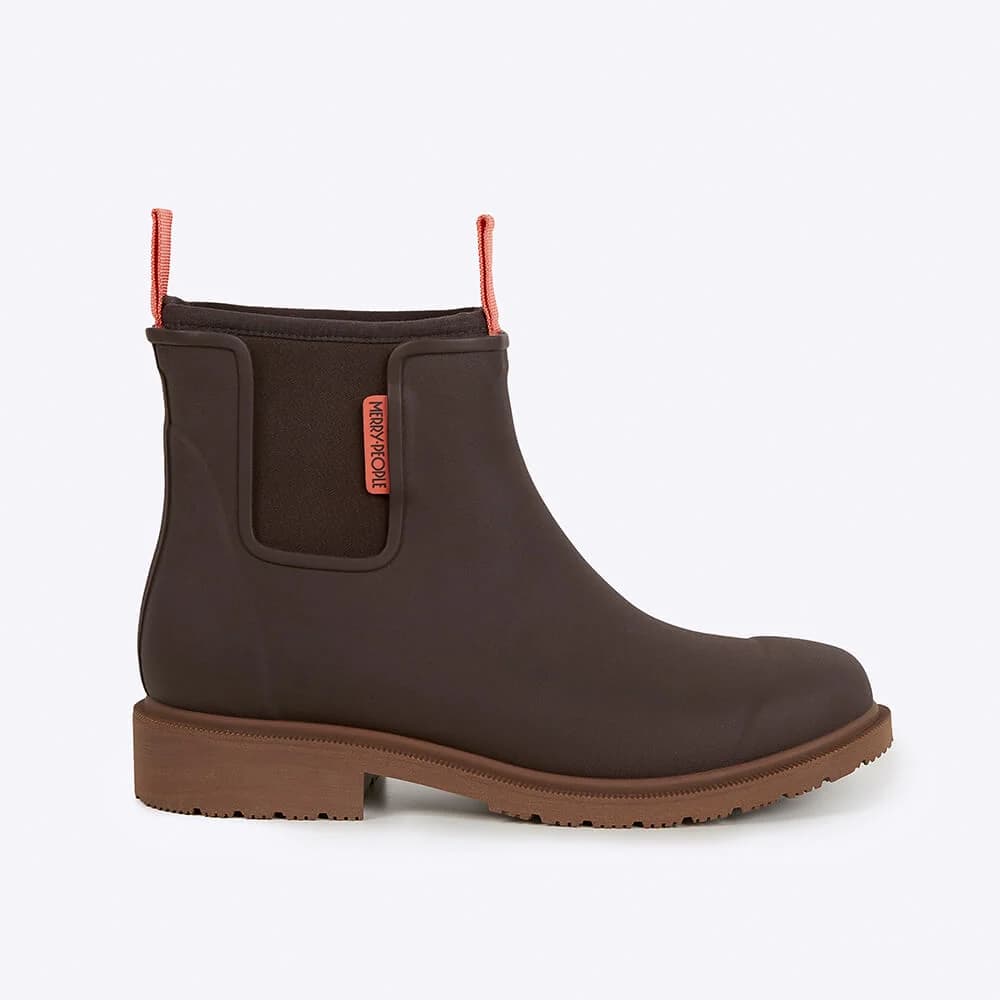 Brown rain boot with orange pink pull handles on a light gray background