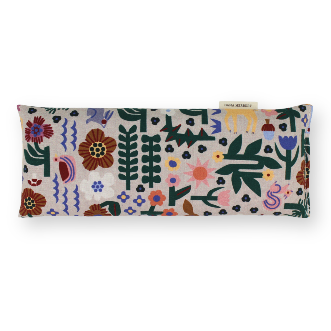 A rectangular aromatherapy eye pillow by Samsé Mérisset featuring a colorful folk-art style botanical and bird pattern on a light beige background, shown against a plain white studio backdrop.