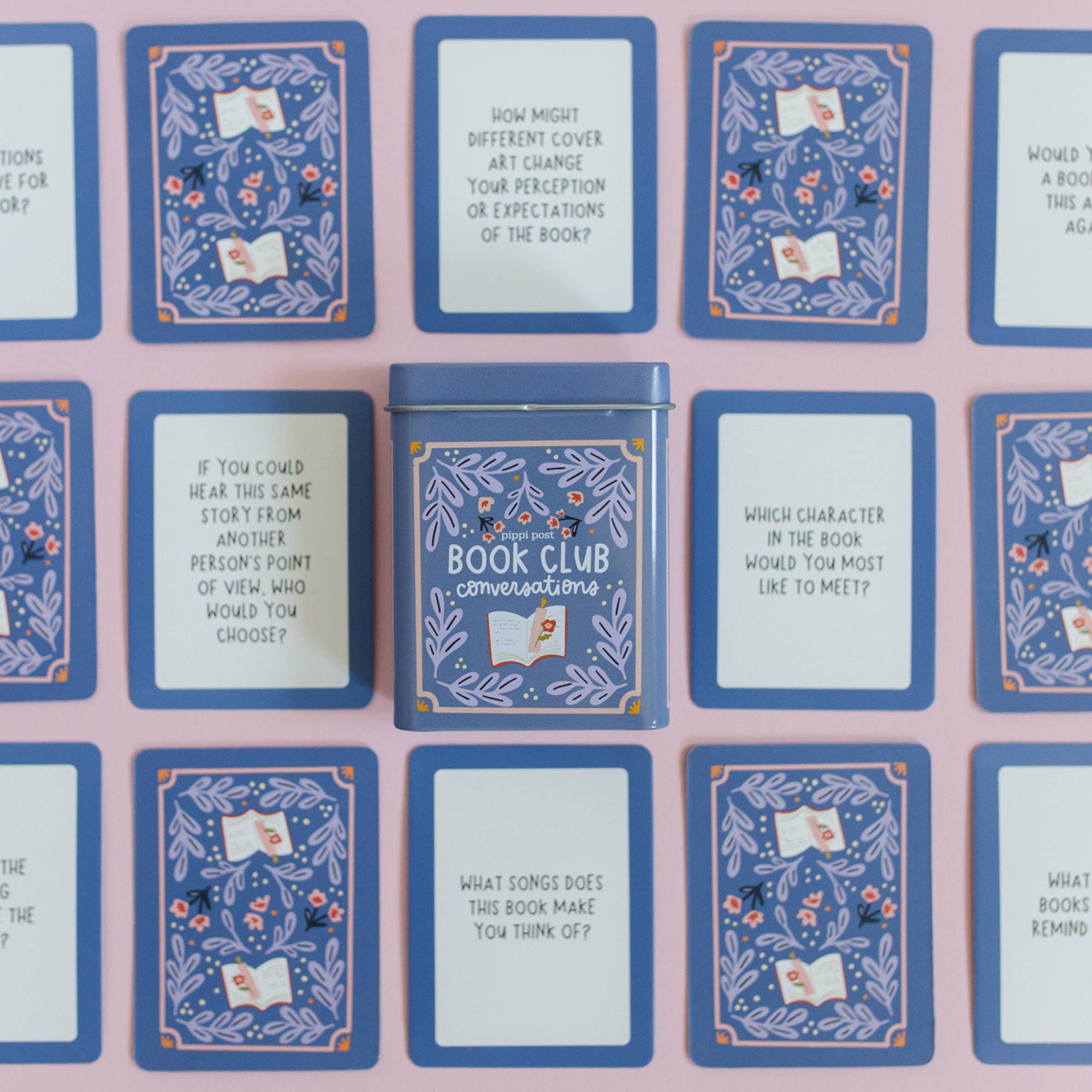 Set of book club discussion cards with a central tin labeled 'Book Club Conversations' on a pink background.
