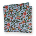 Large aromatherapy hot or cold wrap featuring a dense floral and botanical print on a dusty light blue background. The pattern includes pink, red, orange, and yellow flowers with green leaves and stems.