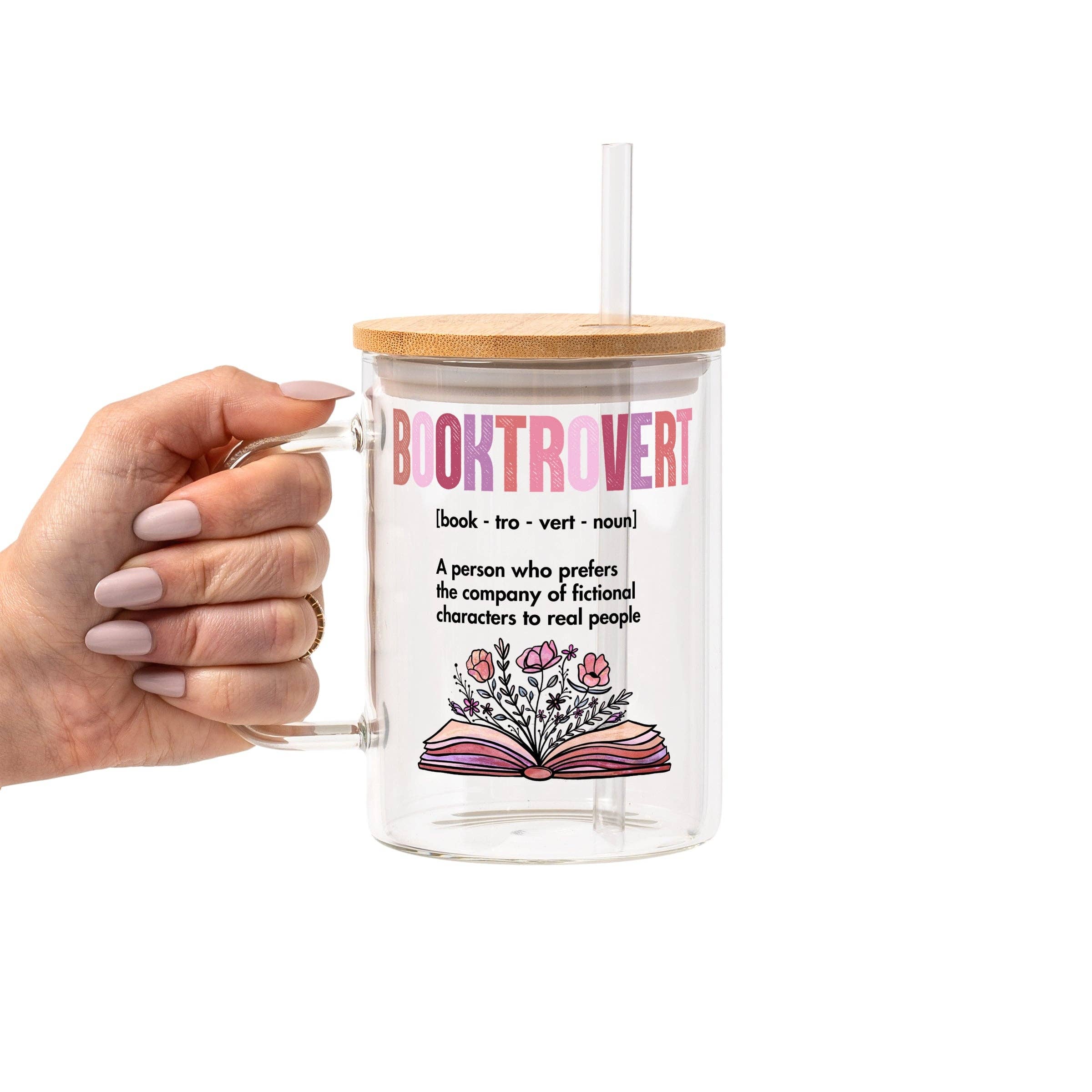 Clear mug with wooden lid and straw, featuring a definition of 'booktrovert' and an illustration of a book with flowers on a white background.