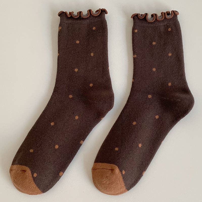 Pair of brown socks with ruffled top and polka dot pattern on a light gray background