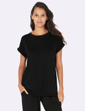 Woman wearing a black t-shirt and pants on a white background