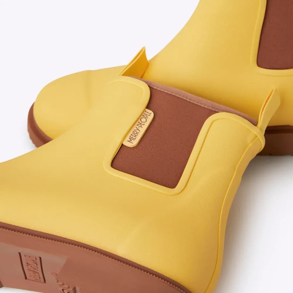 Yellow sandal with brown accents on a white background