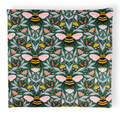 Small aromatherapy hot or cold wrap featuring a detailed botanical and insect pattern on a dark green background, with pink-winged bees, butterflies, flowers, and leaves.