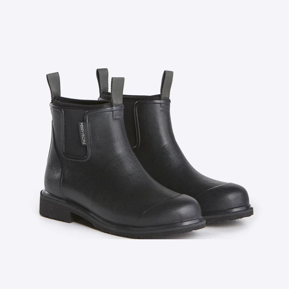 Pair of black rubber rain boots with elastic pull on tabs and neoprene lining on a white background