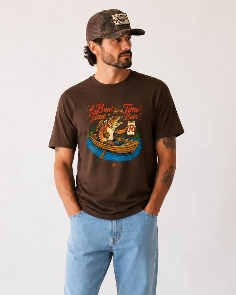 Man in graphic tee with fish drinking a beer.