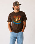 Man in graphic tee with fish drinking a beer.