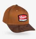 A brown baseball cap with a suede-look brim and a red, white, and black Rainier patch on the front, shown on a light gray background.