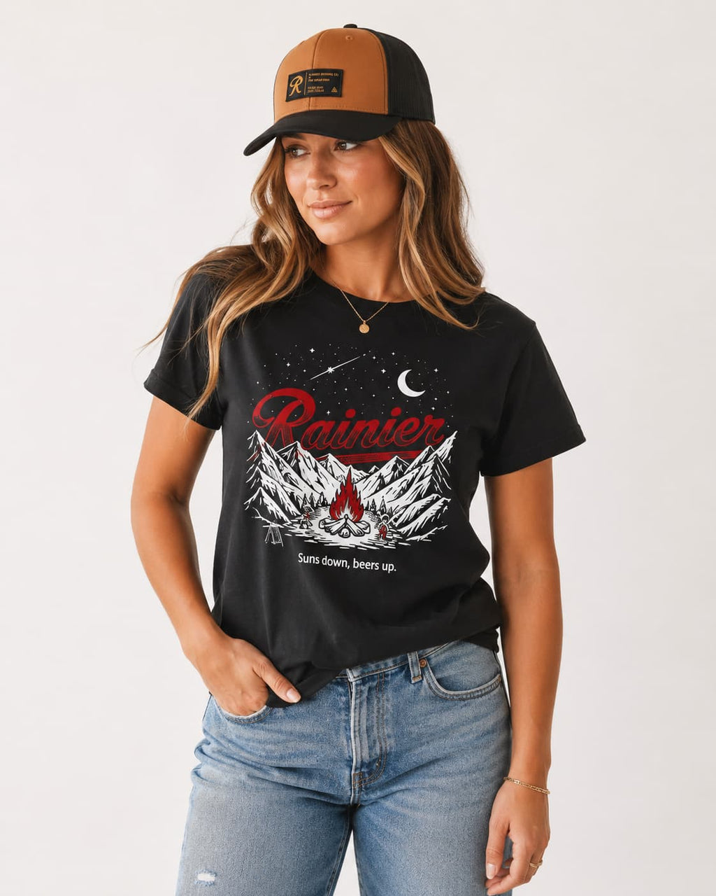 Woman in glow in the dark Rainier Beer graphic tee and snapback hat.
