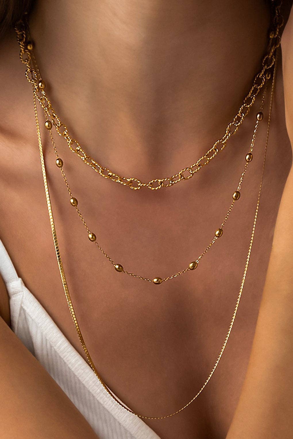 Gold chain necklace on a person's neck
