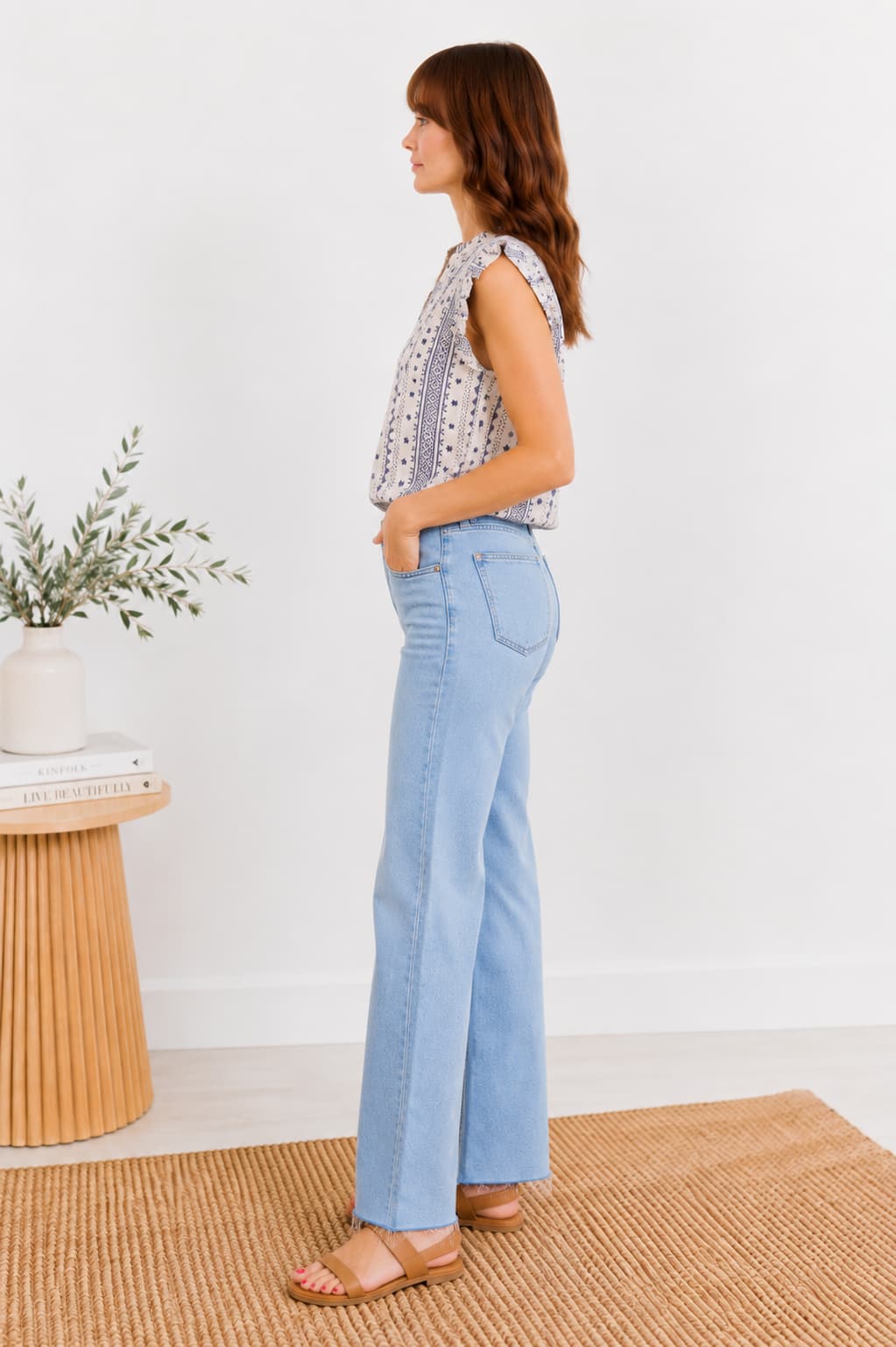 Light blue jeans worn by a person on a neutral background