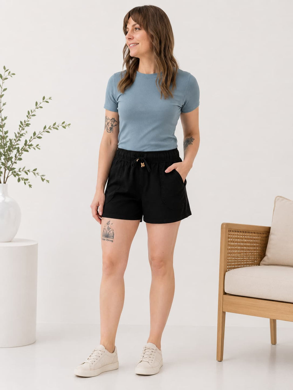 woman wearing black fabric shorts and blue ribbed t shirt