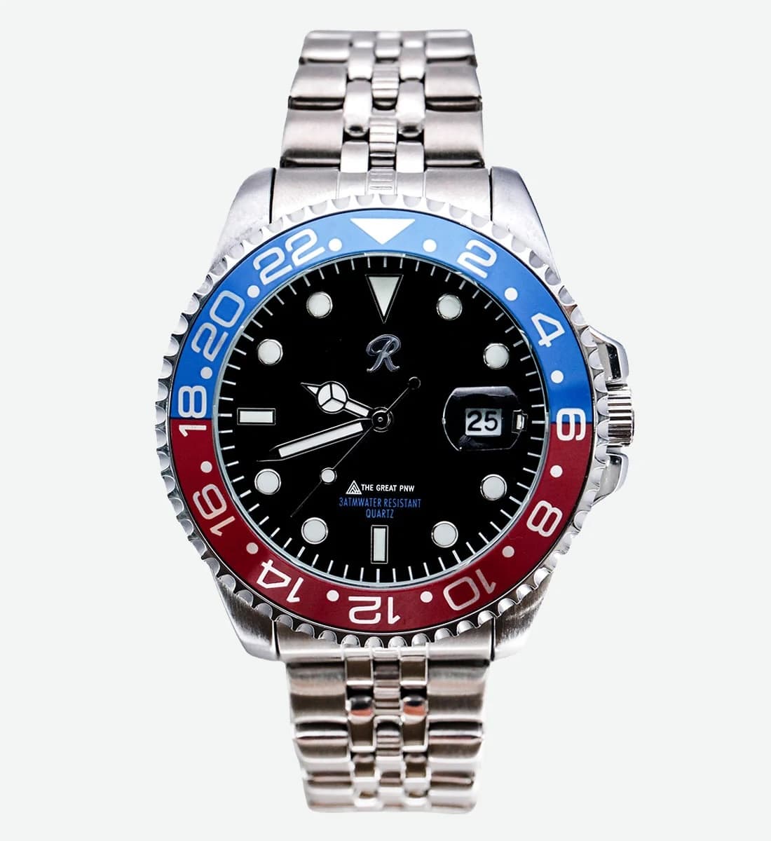 A stainless steel wristwatch with a black dial, a red and blue bezel, and a matching steel link bracelet, shown against a light gray background.