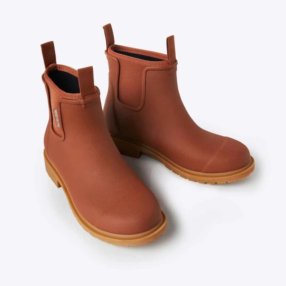 A pair of brown rubber rain boots with elastic side gore panels and pull tabs, shown on a clean white background.