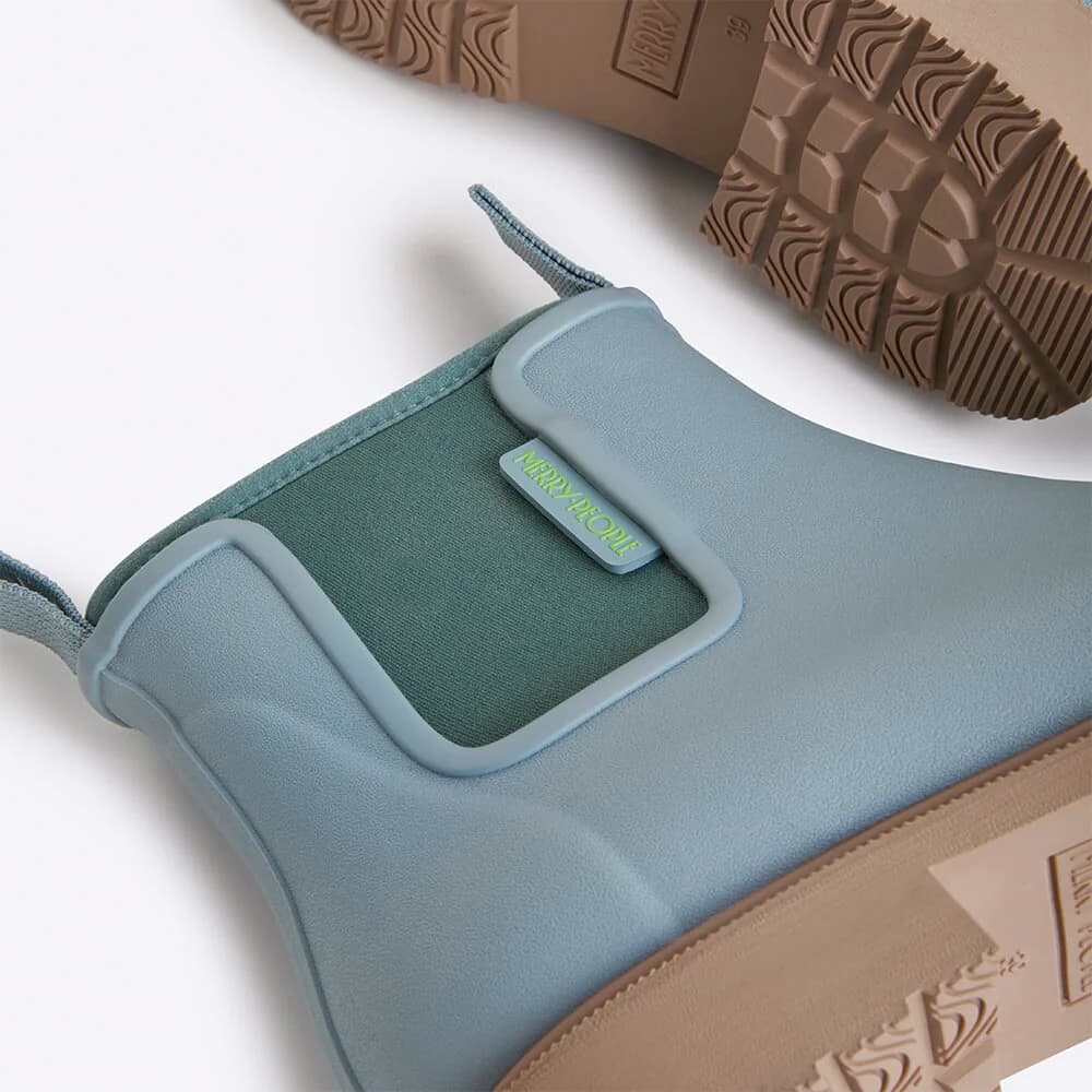 Close-up of a blue shoe insole with neoprene lining with a brand label on a white background
