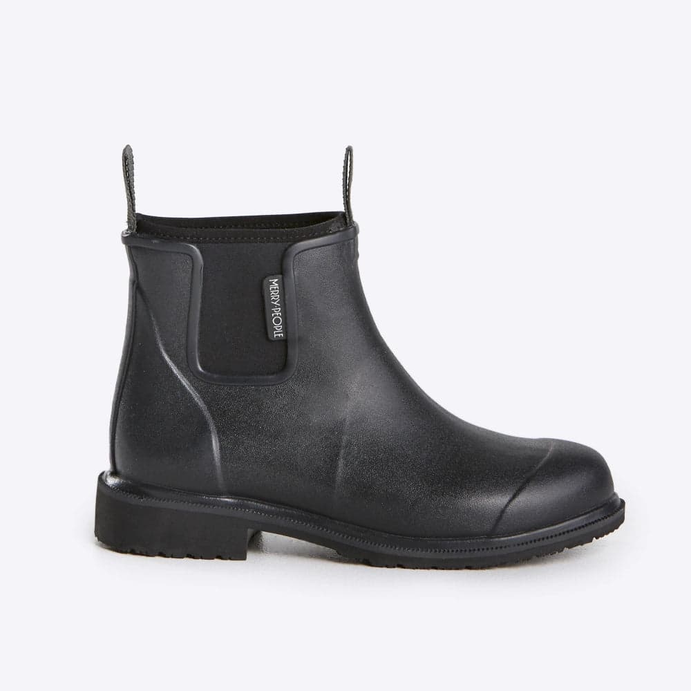 A black rubber Chelsea-style work boot with a pull tab and elastic neoprene side gore, shown from a side profile on a light gray background. The brand name 'Merry People' is visible on a small tag on the side.