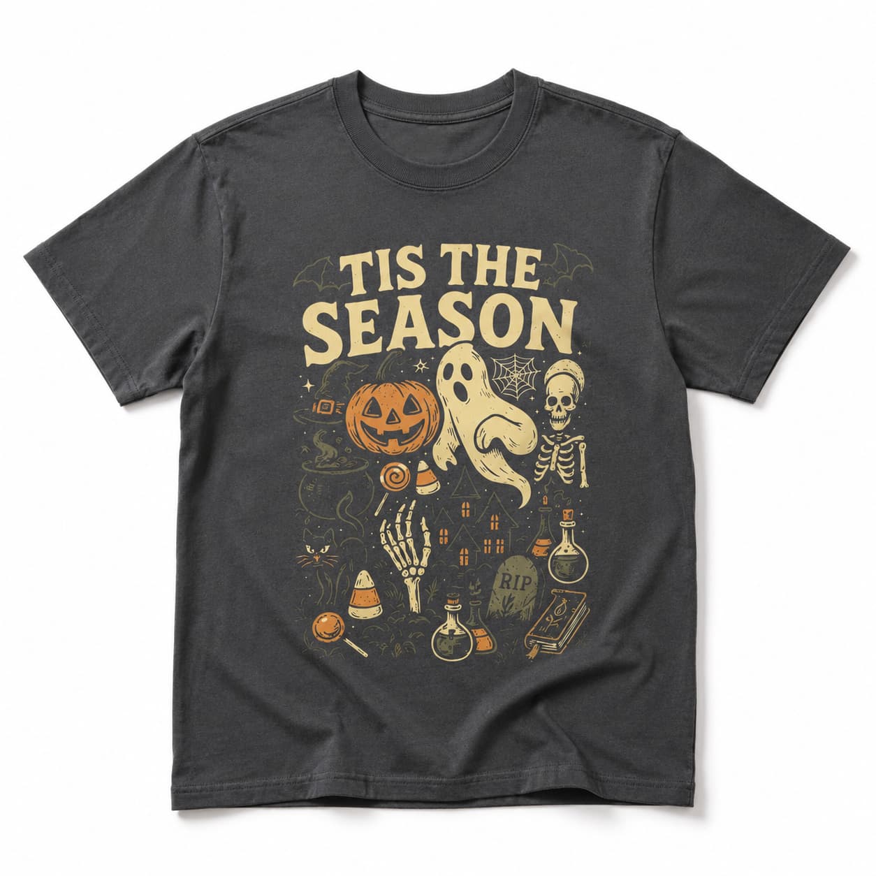 A dark charcoal gray short-sleeve t-shirt with a vintage-style Halloween graphic on the front. The graphic features the text 'TIS THE SEASON' in a distressed cream font above illustrations of a jack-o'-lantern, a ghost, a skeleton, a potion bottle, and other spooky elements.