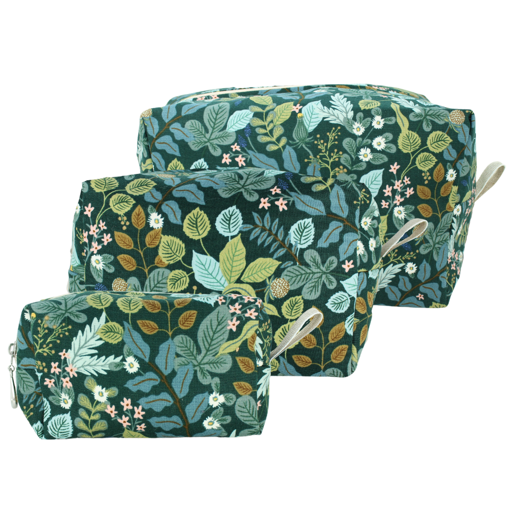 Three nested zippered cosmetic pouches with a dark green botanical leaf pattern, shown on a plain white background.