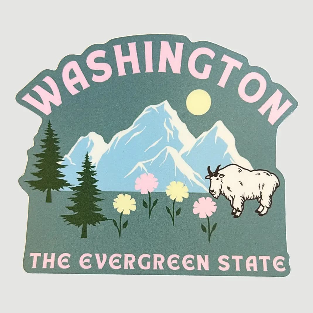 A die-cut sticker featuring a Washington state landscape with pink lettering reading 'WASHINGTON' and 'THE EVERGREEN STATE,' blue mountains, green trees, flowers, and a white goat on a light gray background.